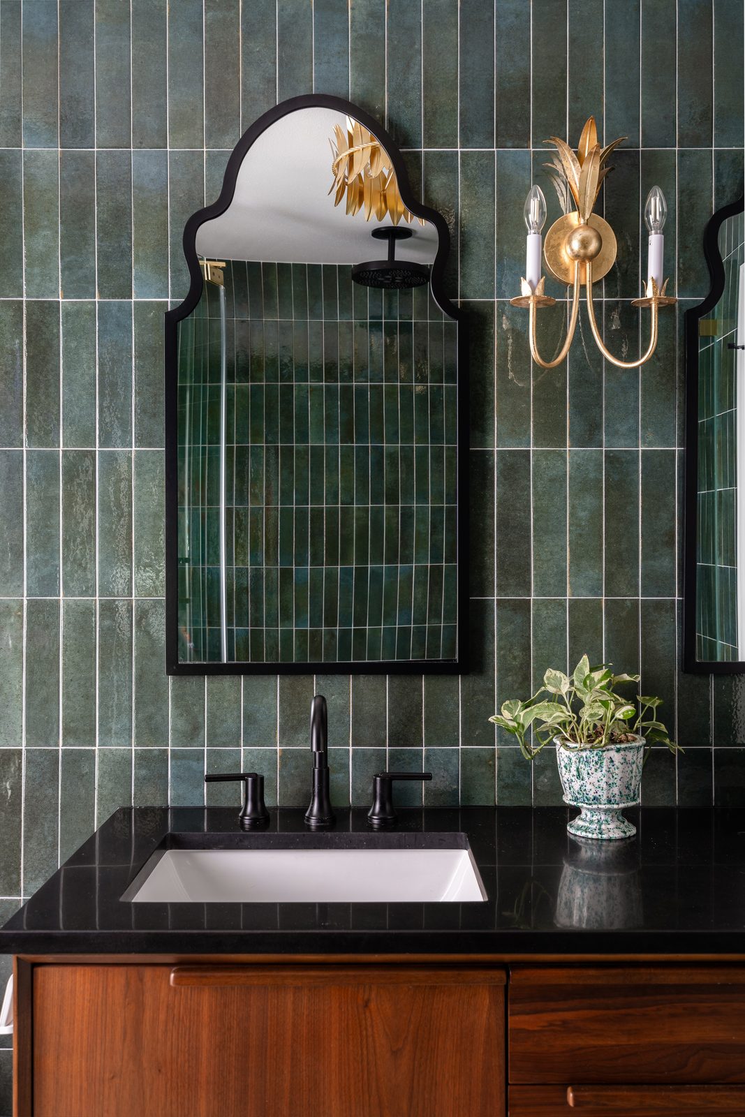 Green tile vanity with arched mirror