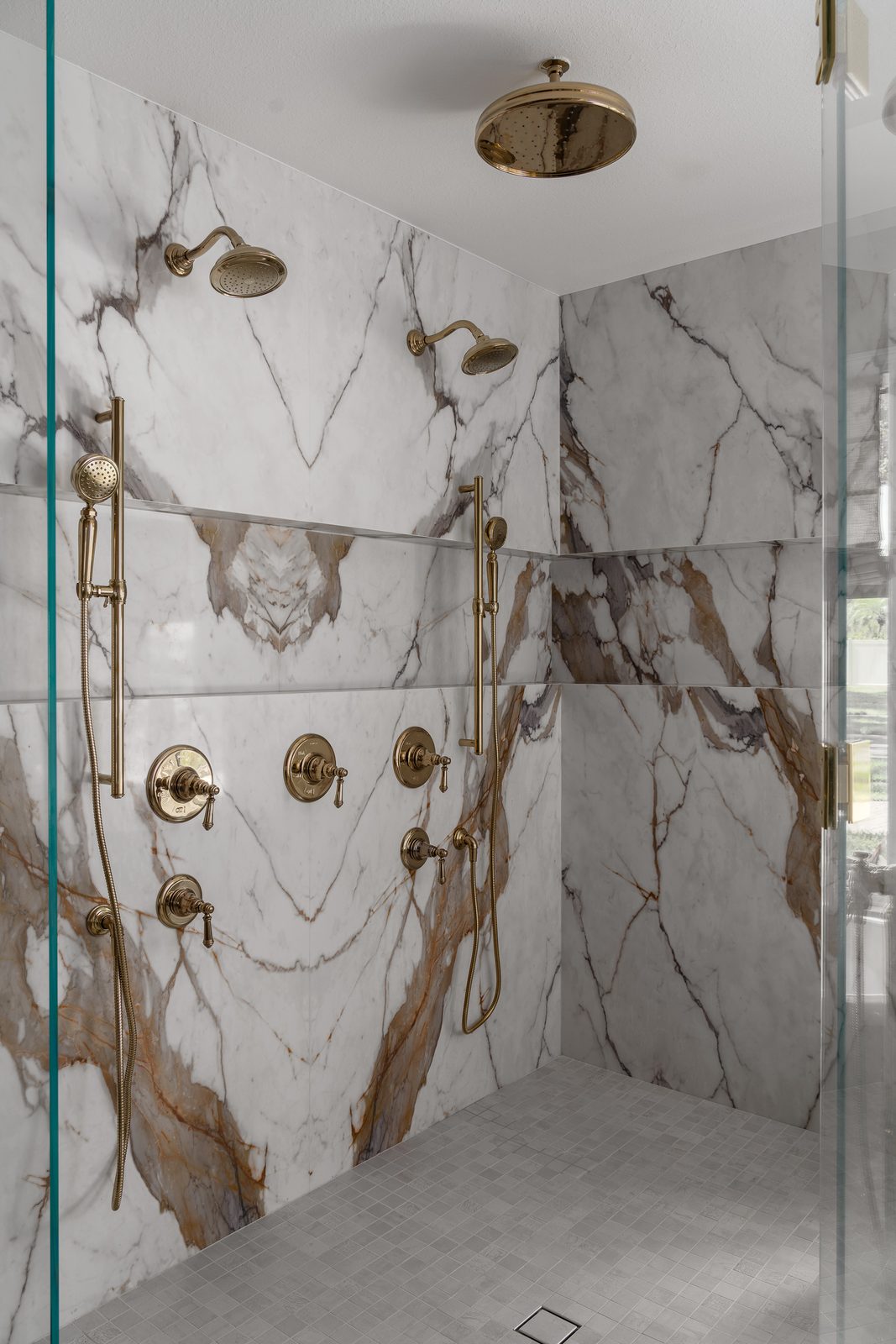 Marble shower with gold fixtures